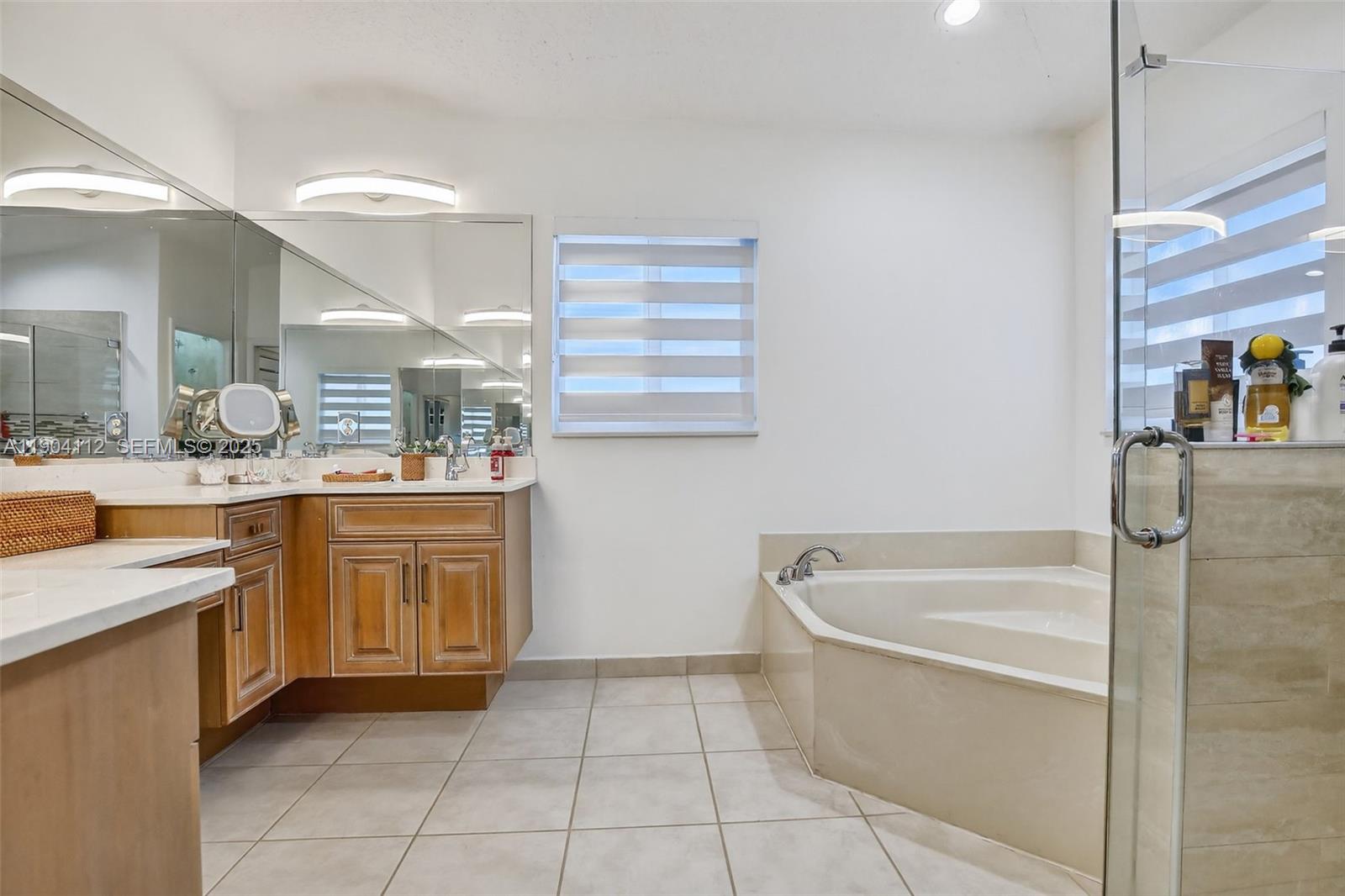 18950 Southwest 16th Street, Unit 1950 Pembroke Pines, FL 33029 - Photo 29 of 51 a bathroom with a granite countertop sink a toilet and bathtub