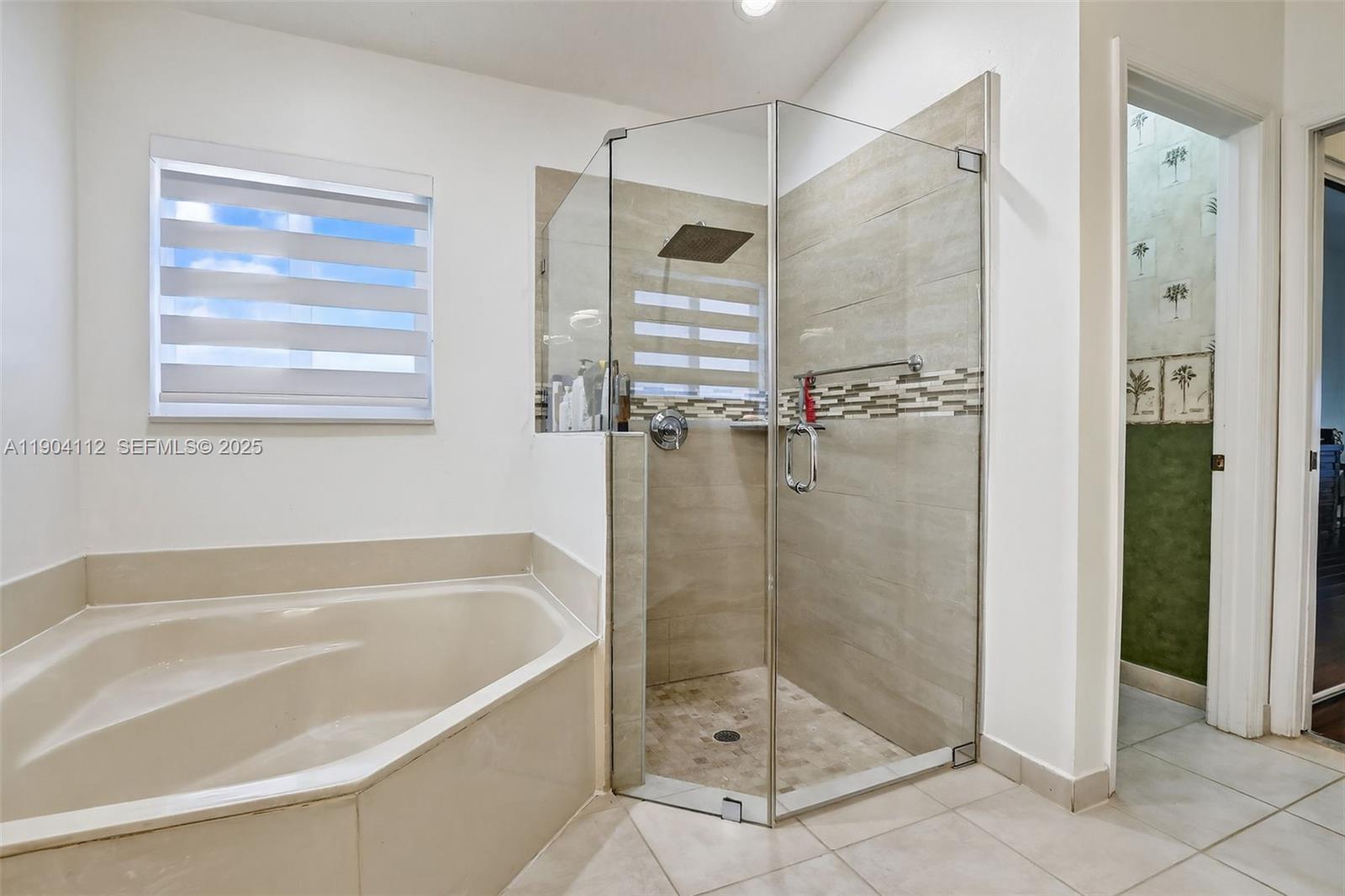 18950 Southwest 16th Street, Unit 1950 Pembroke Pines, FL 33029 - Photo 30 of 51 a bathroom with a shower and a bath tub