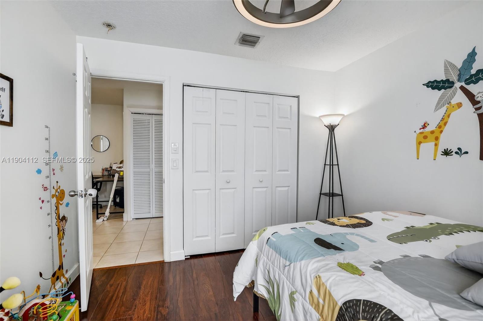 18950 Southwest 16th Street, Unit 1950 Pembroke Pines, FL 33029 - Photo 32 of 51 a bedroom with a bed and a wooden floor