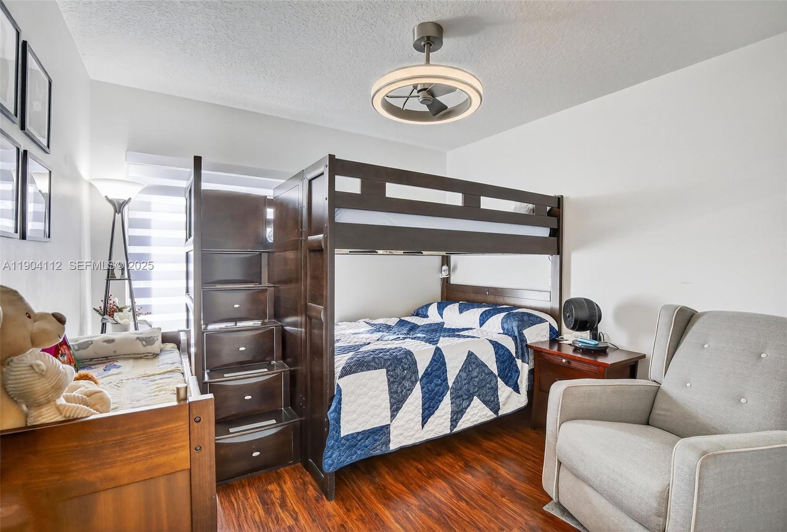 18950 Southwest 16th Street, Unit 1950 Pembroke Pines, FL 33029 - Photo 37 of 51 a bedroom with a bed and wooden floor