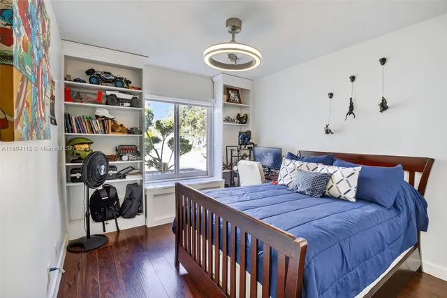 a view of a bench in the garden near a lake