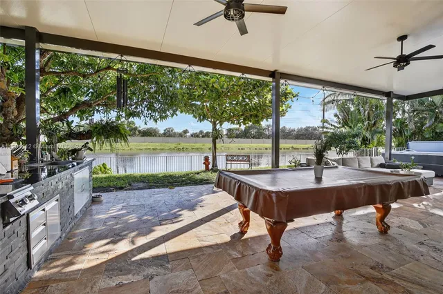 a kitchen view with a stove and garden view