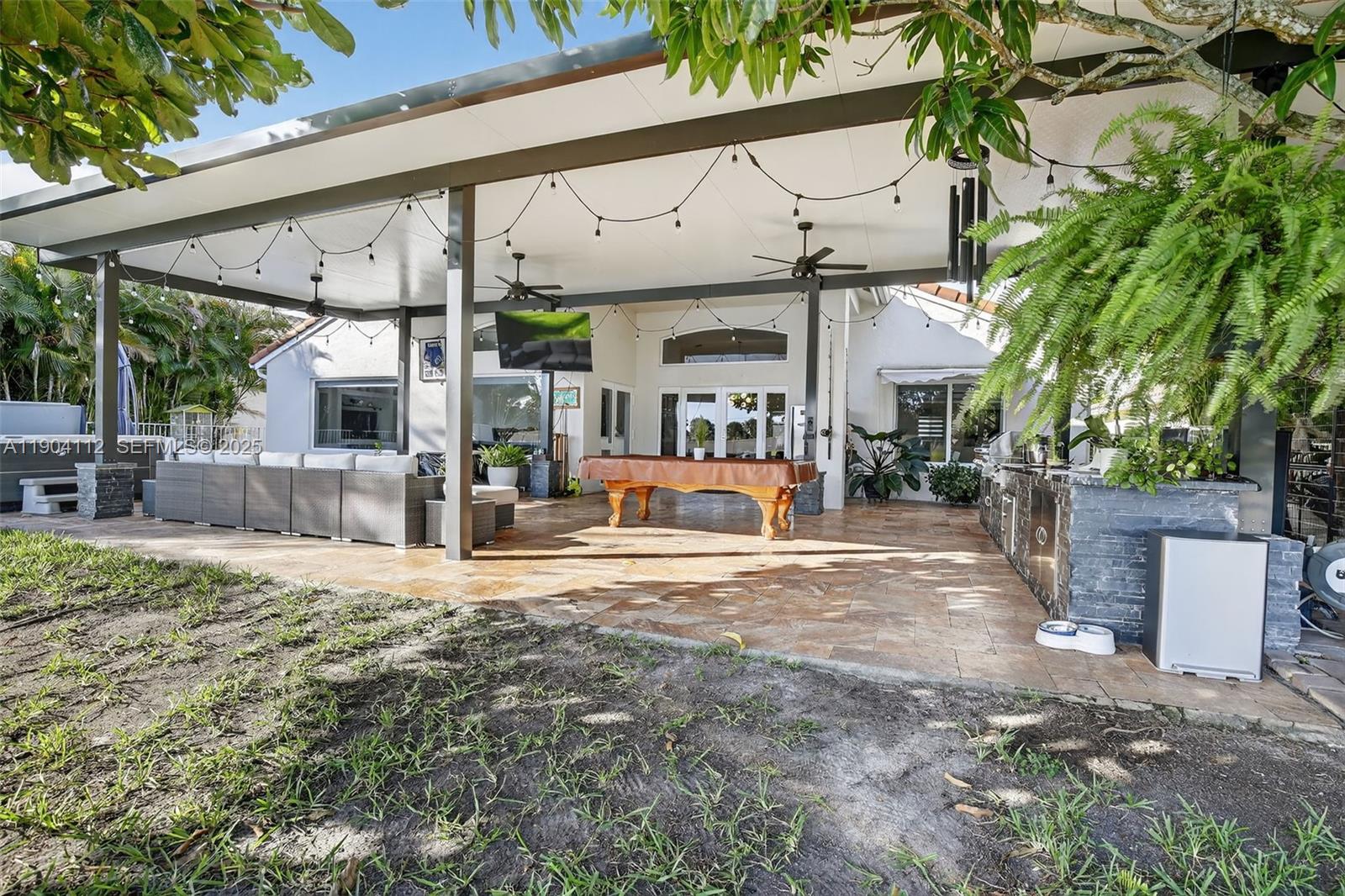 18950 Southwest 16th Street, Unit 1950 Pembroke Pines, FL 33029 - Photo 44 of 51 a view of a house with backyard and sitting area