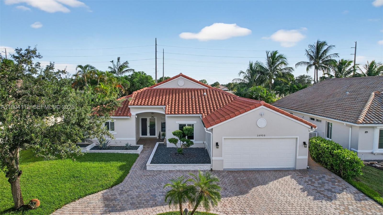 18950 Southwest 16th Street, Unit 1950 Pembroke Pines, FL 33029 - Photo 7 of 51 a front view of a house with a garden