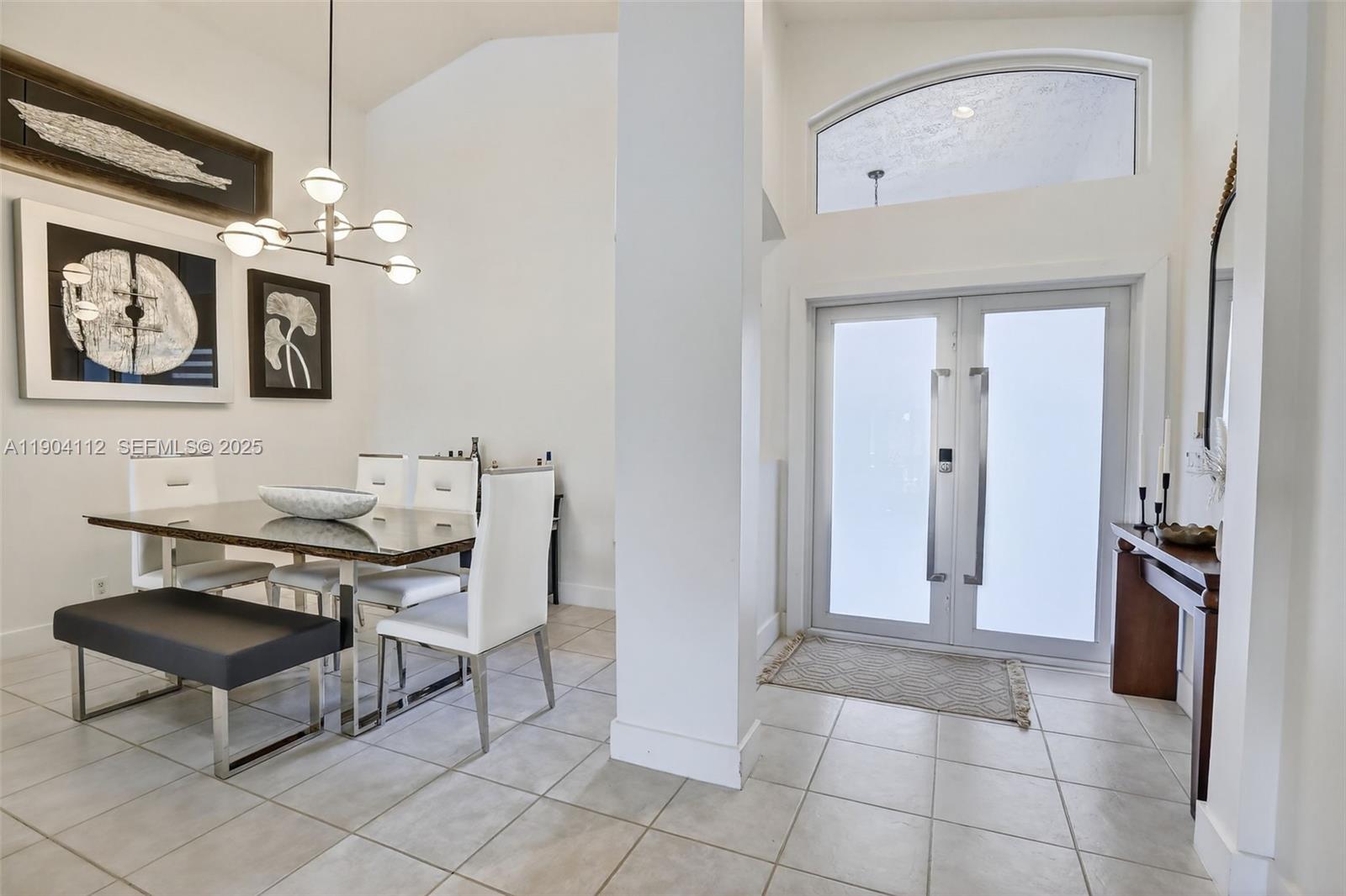18950 Southwest 16th Street, Unit 1950 Pembroke Pines, FL 33029 - Photo 8 of 51 a view of a livingroom with furniture and a chandelier