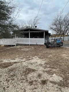 a view of a house with a car parked in front of it