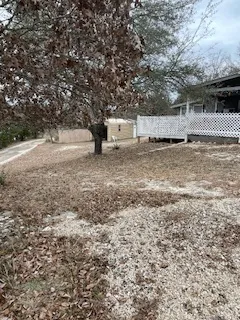 a view of a yard with trees