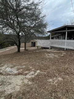 a backyard of a house with large trees
