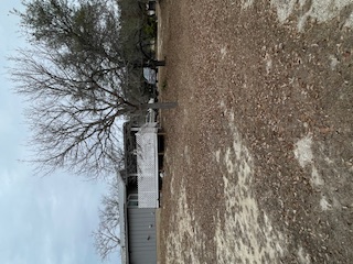 1516 South Ranchero Road South Kerrville, TX 78028 - Photo 8 of 16 a backyard of a house with large trees and outdoor seating