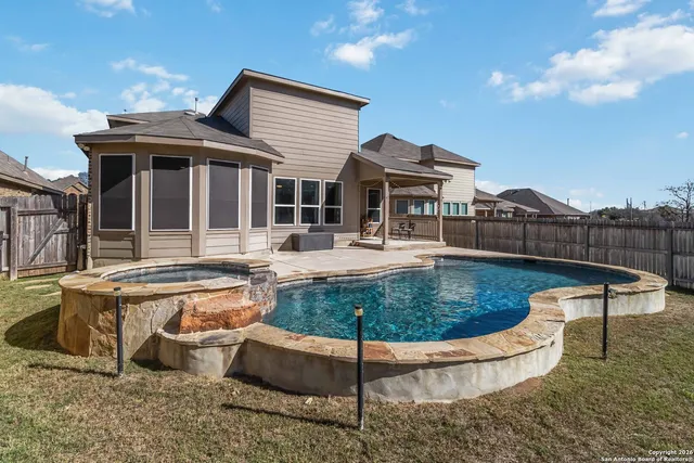 a view of a house with pool table chairs and a fire pit