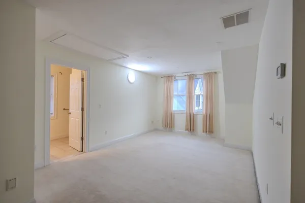 a view of an empty room and a window