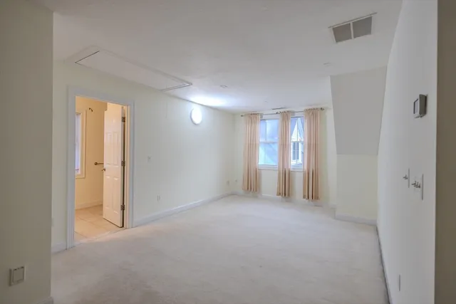 a view of an empty room and a window