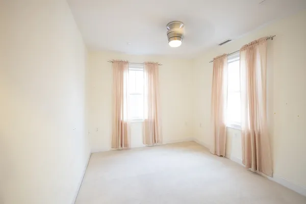 an empty room with windows and closet