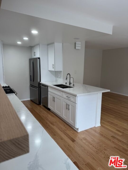 a kitchen with stainless steel appliances a sink stove and refrigerator