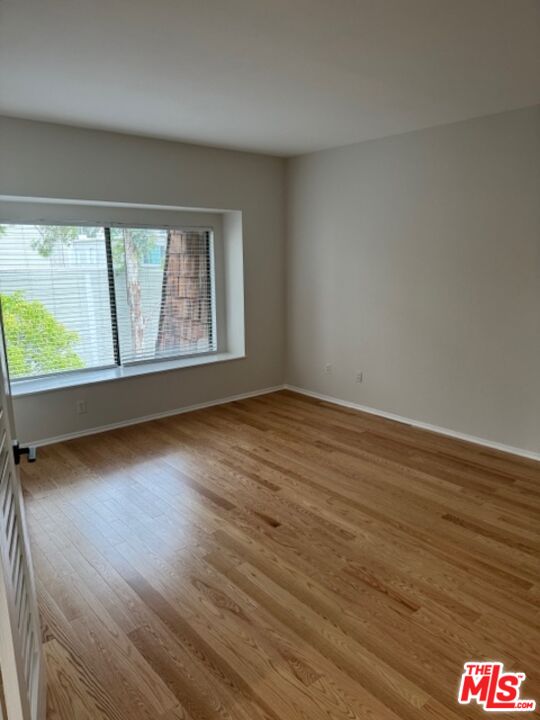 13322 Maxella Avenue, Unit 2 Marina del Rey, CA 90292 - Photo 15 of 20 an empty room with wooden floor and windows