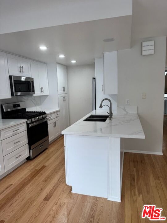 13322 Maxella Avenue, Unit 2 Marina del Rey, CA 90292 - Photo 2 of 20 a kitchen with kitchen island stainless steel appliances a sink and a stove