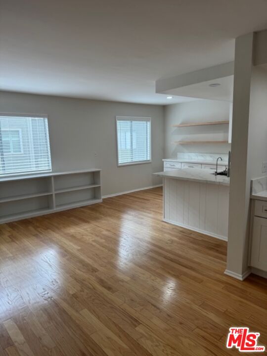13322 Maxella Avenue, Unit 2 Marina del Rey, CA 90292 - Photo 4 of 20 a view of an empty room with a window and wooden floor
