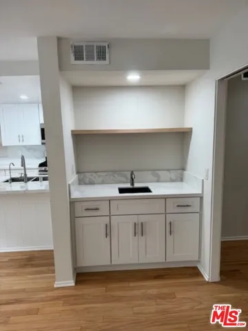a kitchen with stainless steel appliances granite countertop a sink and a stove