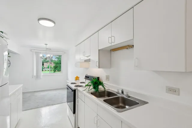a kitchen with a sink and a refrigerator