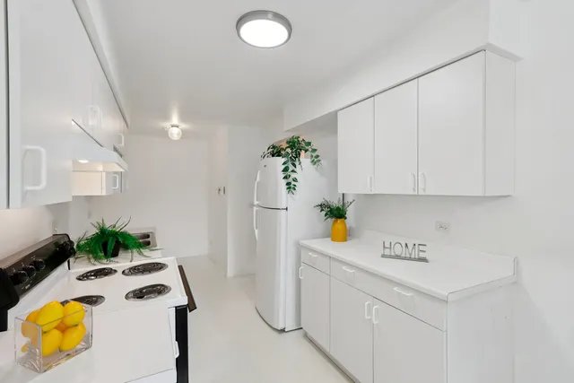 a view of kitchen with white cabinets