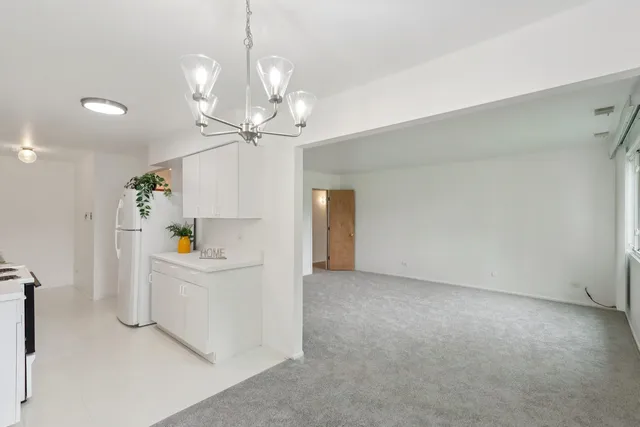a view of a kitchen with furniture and wooden floor
