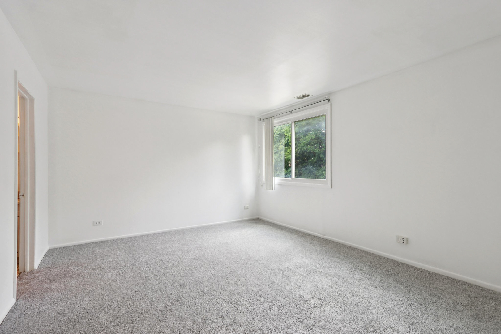 2650 Brookwood Way Drive, Unit 201B Rolling Meadows, IL 60008 - Photo 18 of 25 an empty room with windows