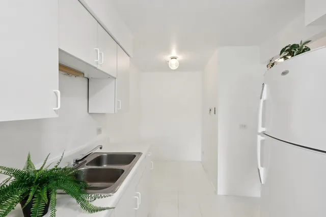 a kitchen with a sink and refrigerator