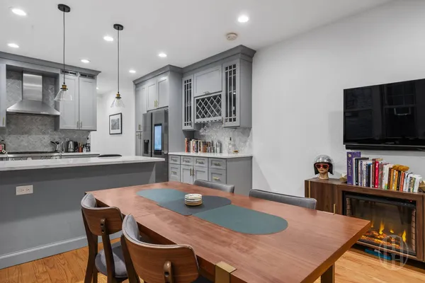 a kitchen with a table chairs refrigerator and microwave