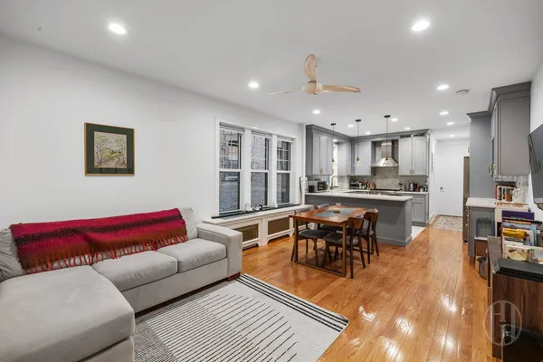 a living room with furniture kitchen view and a table