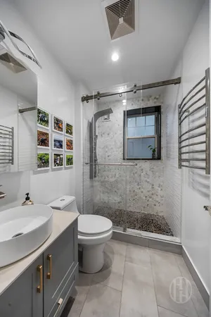 a bathroom with a sink toilet and shower
