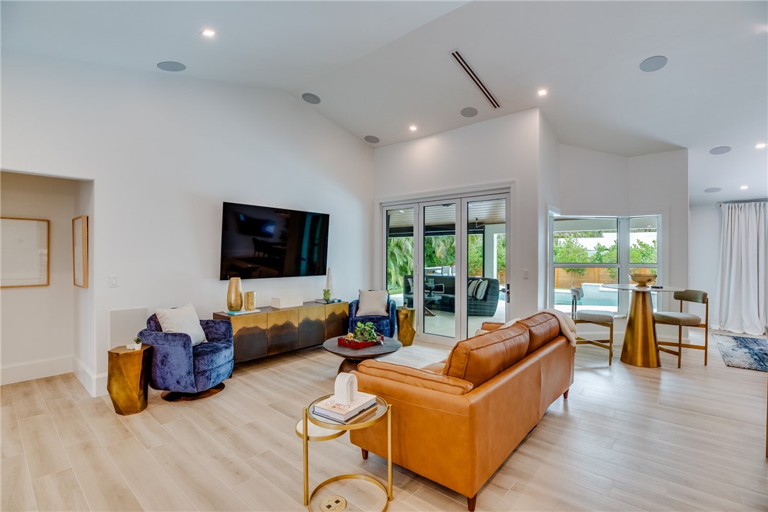 700 Holly Road Vero Beach, FL 32963 - Photo 11 of 36 a living room with furniture a flat screen tv and a large window