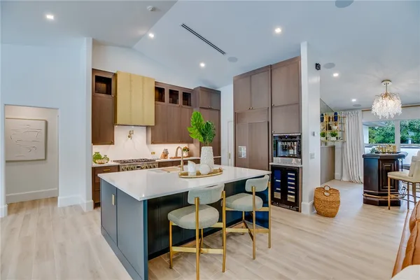 a large kitchen with a table and chairs in it