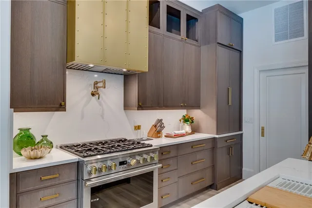 a kitchen with stainless steel appliances stove and cabinets