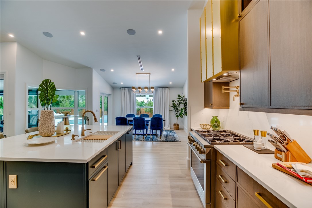 700 Holly Road Vero Beach, FL 32963 - Photo 19 of 36 a kitchen with lots of counter top space and living room
