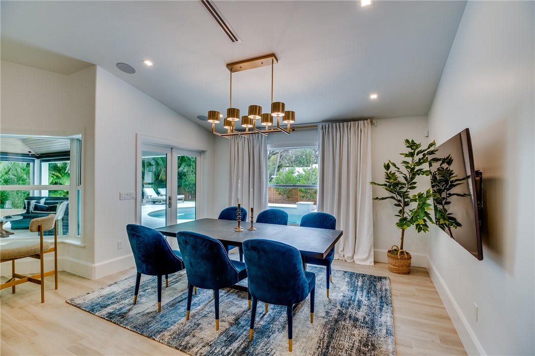 700 Holly Road Vero Beach, FL 32963 - Photo 20 of 36 a view of a dining room with furniture window and wooden floor