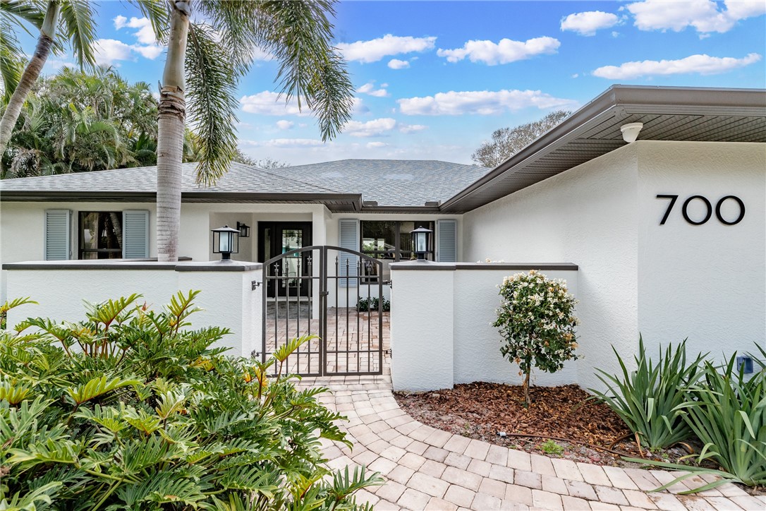 700 Holly Road Vero Beach, FL 32963 - Photo 2 of 36 a front view of a house with garden