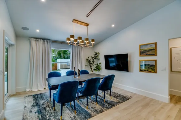 a view of a dining room with furniture and a chandelier