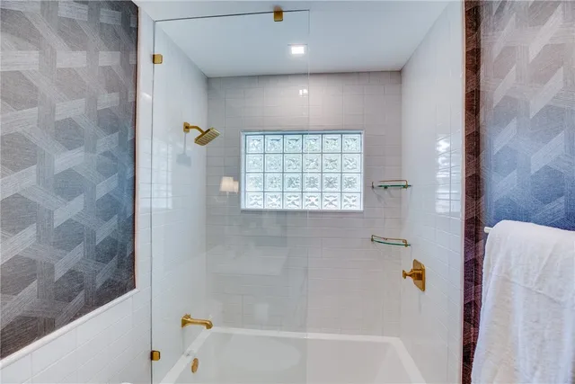 a bathroom with a bathtub and a shower