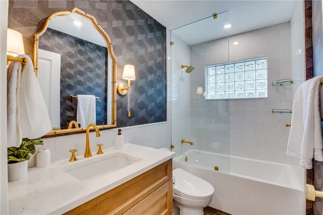 a bathroom with a sink a toilet and bathtub