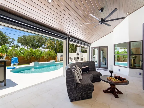a living room with patio furniture and a fireplace