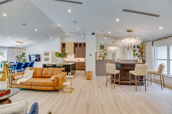a living room with furniture and kitchen view