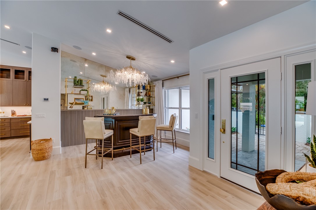 700 Holly Road Vero Beach, FL 32963 - Photo 5 of 36 a view of a dining room with furniture and wooden floor