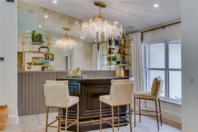 a view of a dining room with furniture and chandelier