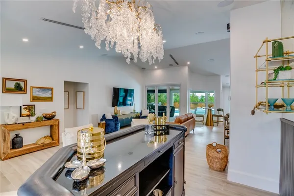 a living room with furniture and a chandelier