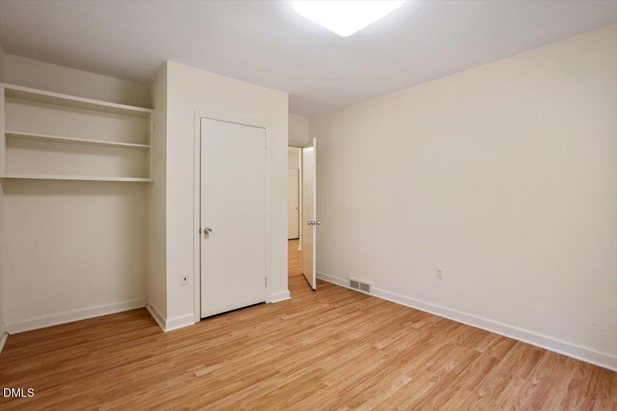 904 Kings Mill Road Chapel Hill, NC 27517 - Photo 15 of 33 a view of an empty room with wooden floor and closet