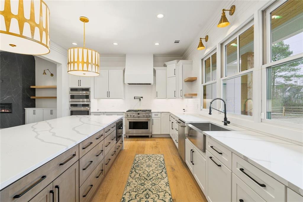 555 Lower Birmingham Road Canton, GA 30115 - Photo 56 of 104 a large kitchen with stainless steel appliances granite countertop a sink and cabinets