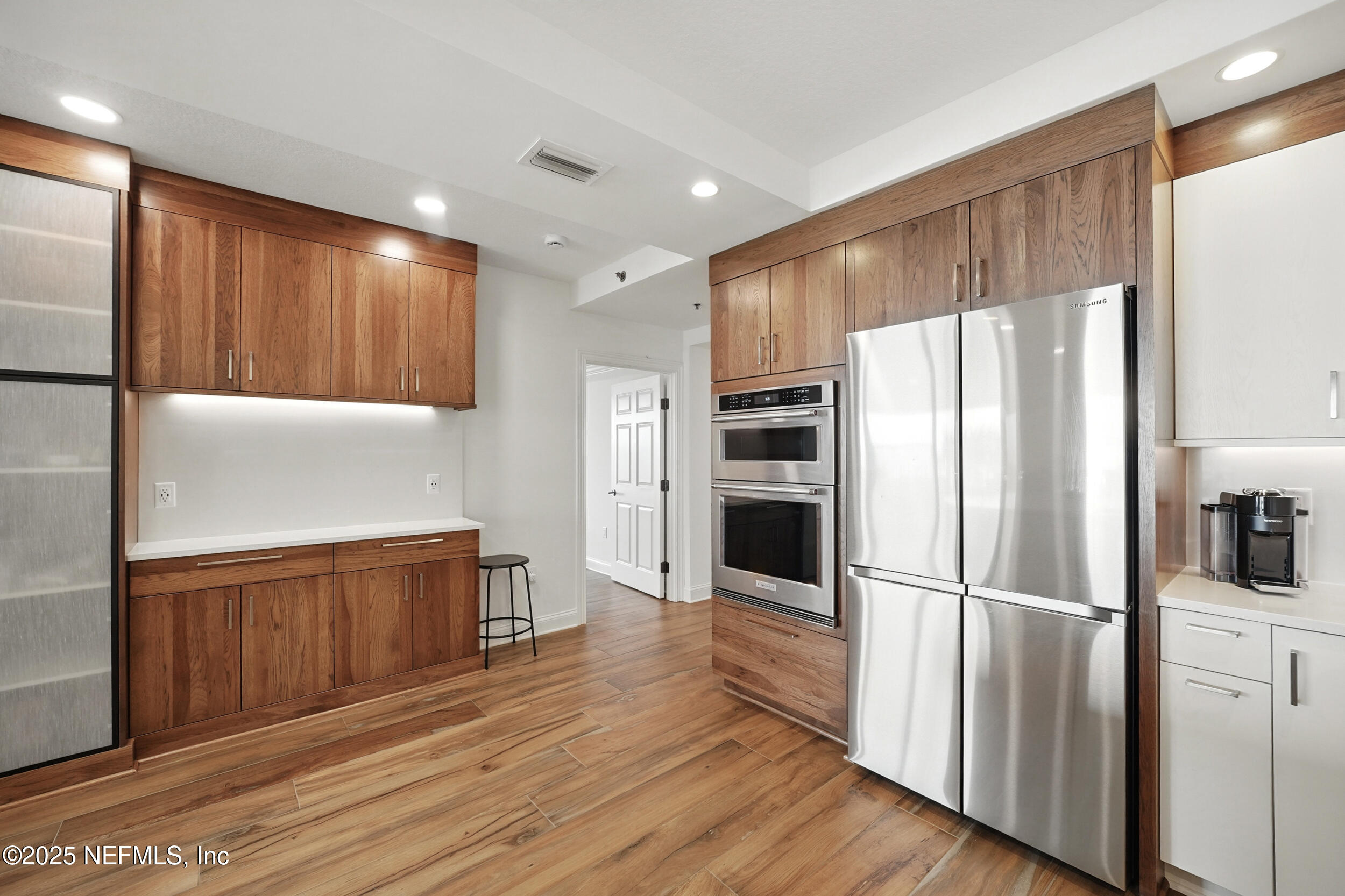 1505 1st Street South, Unit 302 Jacksonville Beach, FL 32250 - Photo 11 of 57 a kitchen with granite countertop stainless steel appliances a refrigerator and cabinets