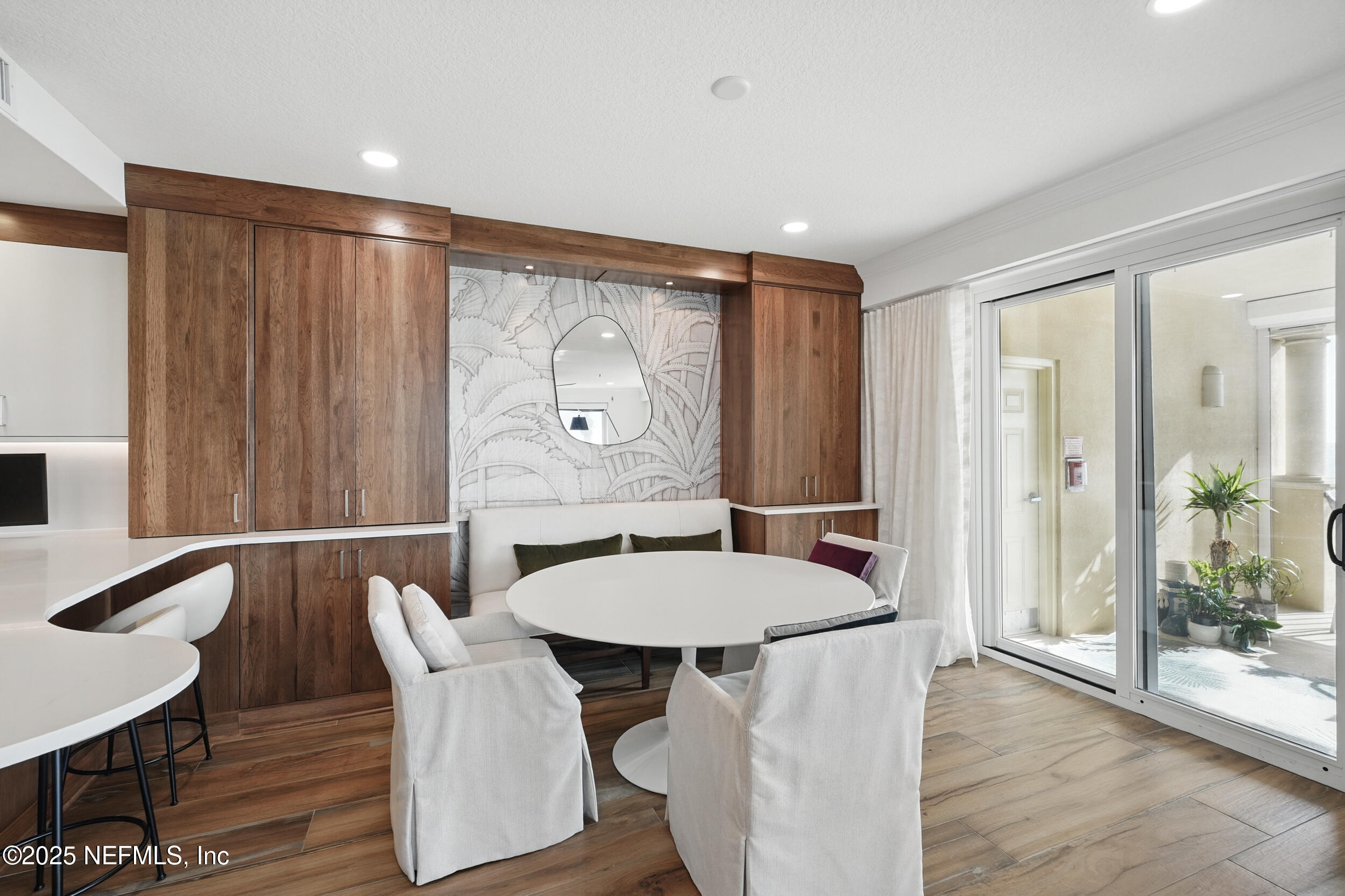 1505 1st Street South, Unit 302 Jacksonville Beach, FL 32250 - Photo 14 of 57 a view of a dining room with furniture and wooden floor