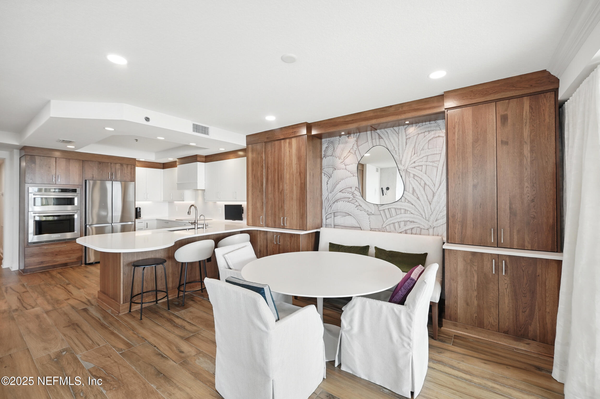 1505 1st Street South, Unit 302 Jacksonville Beach, FL 32250 - Photo 15 of 57 a view of a dining room with furniture window and wooden floor