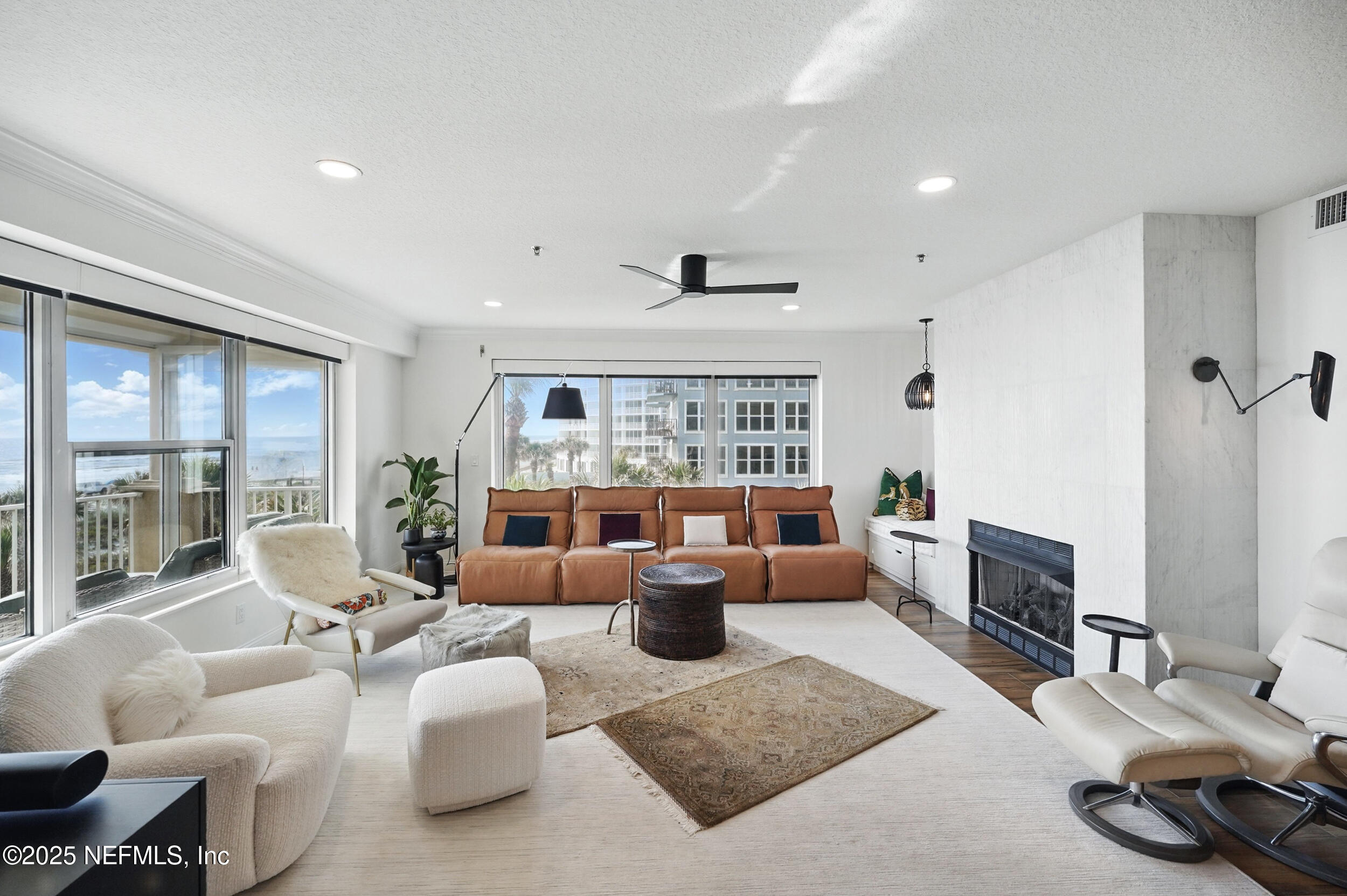 1505 1st Street South, Unit 302 Jacksonville Beach, FL 32250 - Photo 16 of 57 a living room with furniture a flat screen tv and a large window